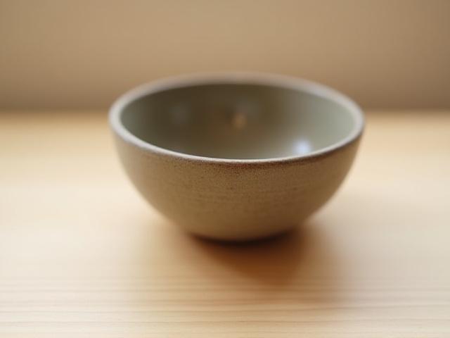 A handmade ceramic meditation bowl with a soft glow